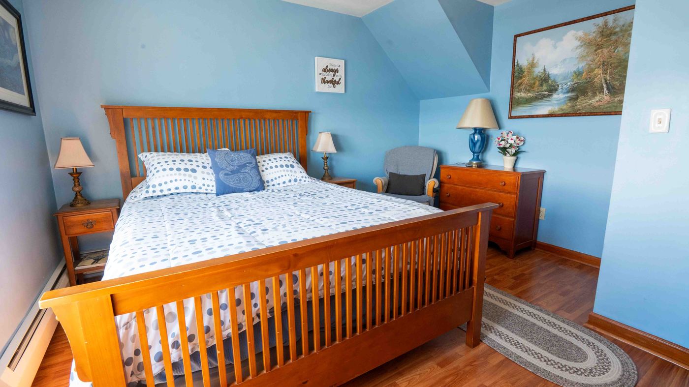 A bedroom at Sunset Paradise with a lake-inspired blue color scheme